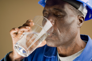 Construction worker drinking a glass of water