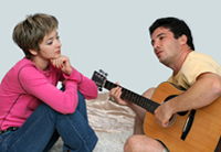 Man plays guitar, therapist listens