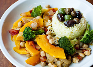 healthy plate of food, including rice, nuts, and vegetables