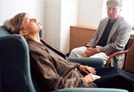 patient in chair being hypnotized by professional