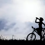 silhouette of person on a bicycle