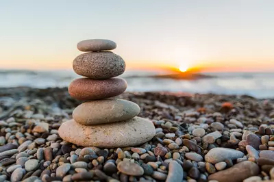 stacked rocks in front of sunset