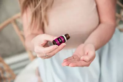 person holding an essential oil
