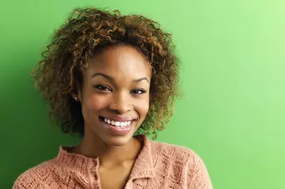 happy woman in front of green background