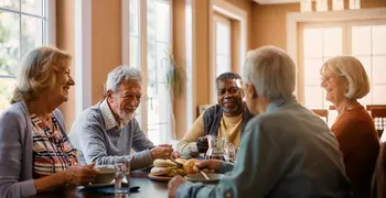 elderly people sitting at a table