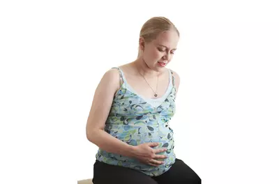 pregnant woman against white background
