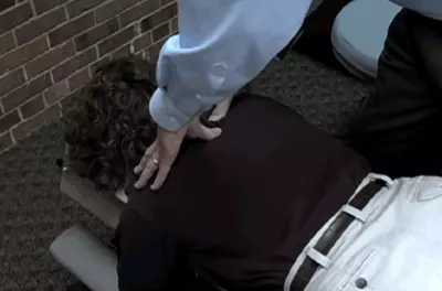 chiropractor's hands on a patient's back
