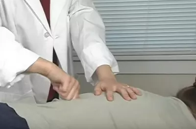 hands massaging a back