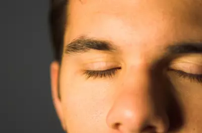 Close-up of man's eyes, which are closed