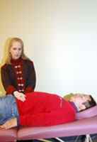 Woman practicing Reiki on man