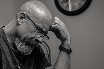 black and white photo of man thinking