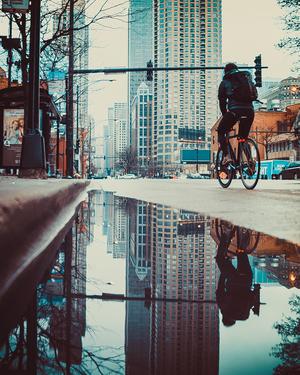 bicyclist riding through a city street
