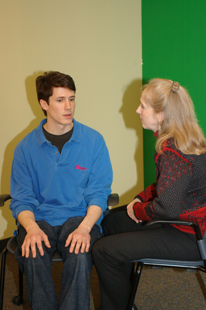 reiki practitioner talking with a client