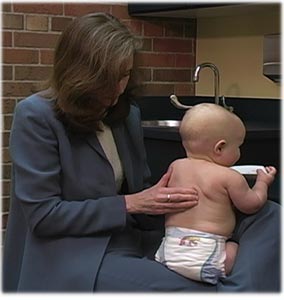 Chiropractor holding a baby on her lap