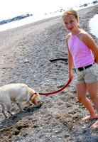 Girl looking happy walking her dog