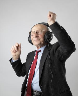 elderly man listening to headphones 