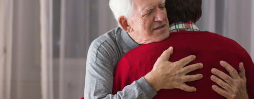 Two men hugging