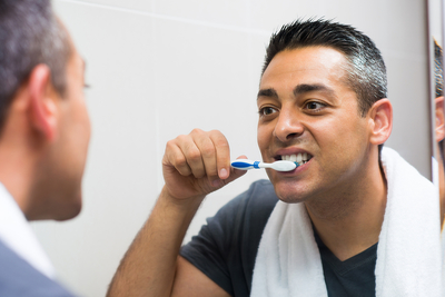 man brushing teeth 