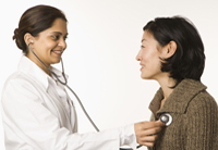 doctor listening to patient's heartbeat