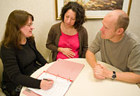 pregnant couple meeting with midwife