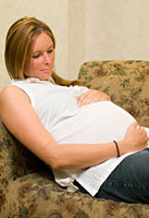 pregnant woman relaxing at home