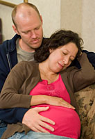 pregnant couple relaxing at home