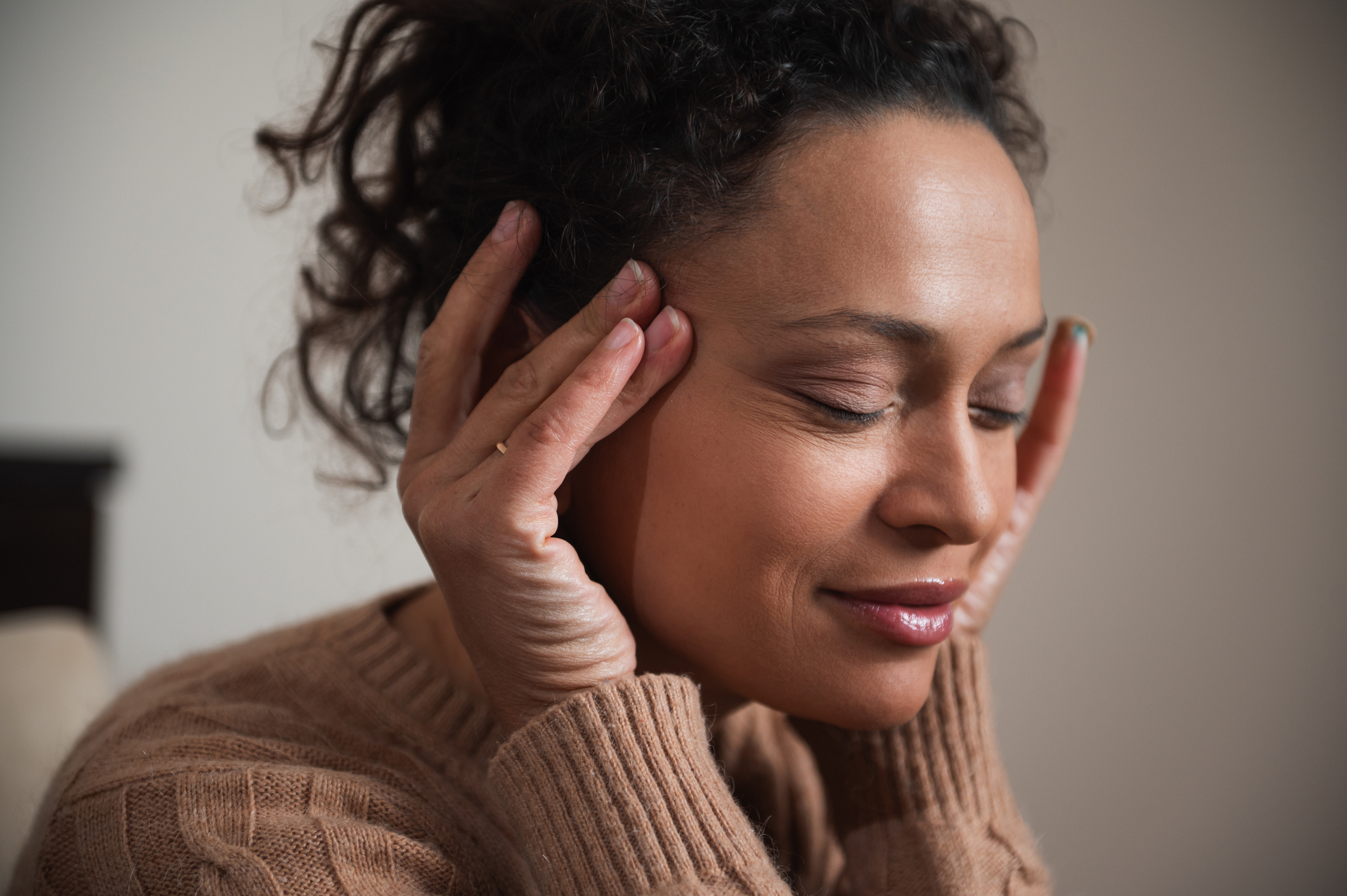 Person applying acupressure to their temples