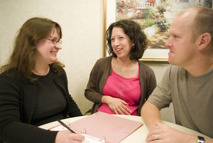 Pregnant couple talking to midwife