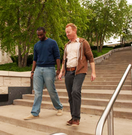 Two men walking down stairs.