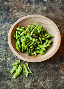 close up of a bowl of green edamame