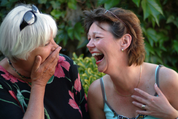 two middle-aged friends laughing together
