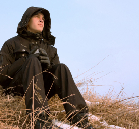 Depressed man sitting by lake.