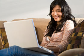 Woman checks messages on her laptop