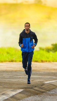 lone runner jogging down a path in the morning