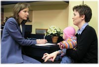 Mother with child talking with chiropracter