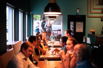 group of people eating together at a restaurant