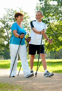 senior couple nordic walking outside