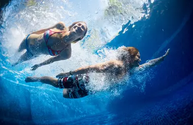 people swimming in a pool. 