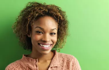 happy woman in front of green background