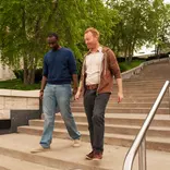 two people walking down stairs