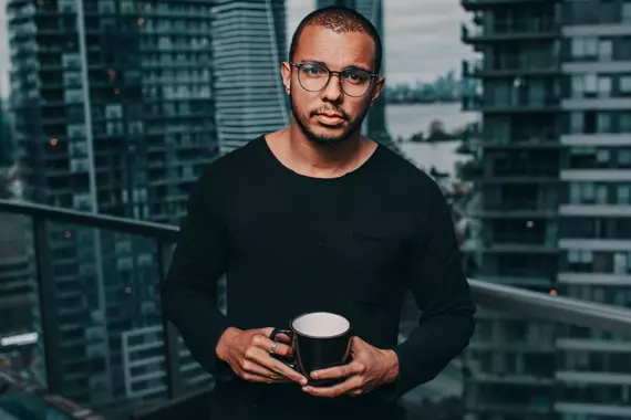 Person holding a cup of coffee.