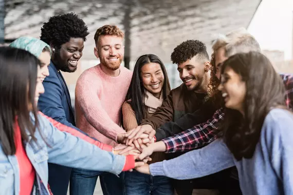 group of friends stacking hands together