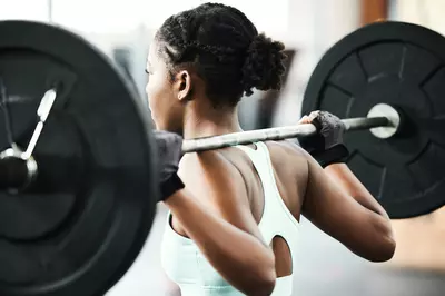 woman squatting with a barbell