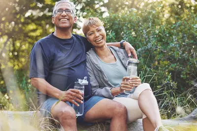 elderly couple smiling in a park