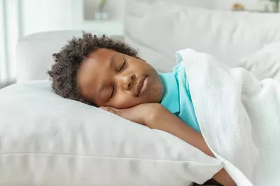 boy sleeping in bed 