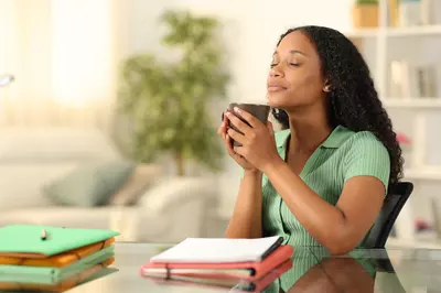 person with eyes closed holding a mug