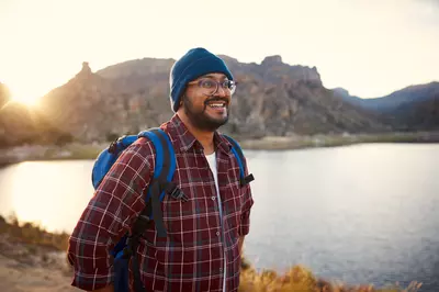 man in flannel hiking