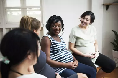 pregnant women talking in a group