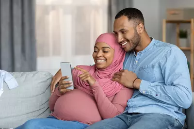 pregnant woman and her partner on phone