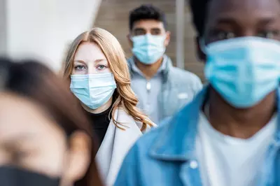 woman in a crowd wearing masks
